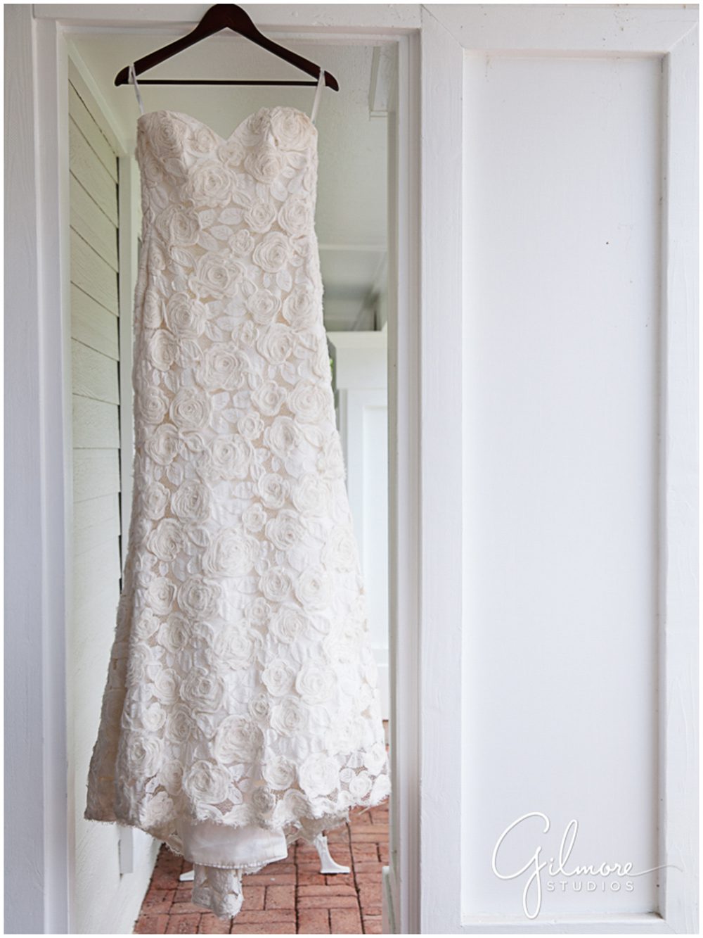 wedding dress hanging on front porch