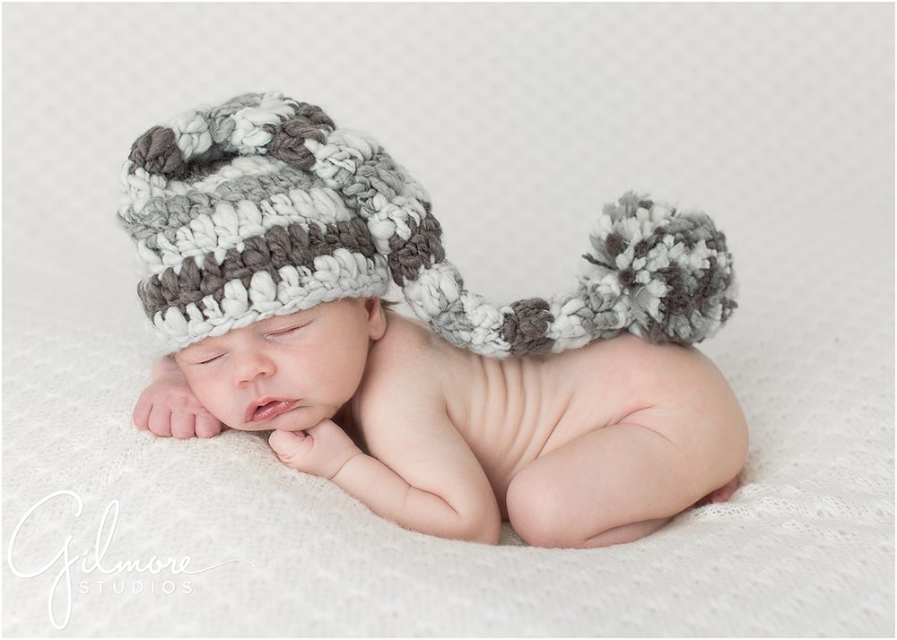newborn baby boy wearing a grey and white elf beanie