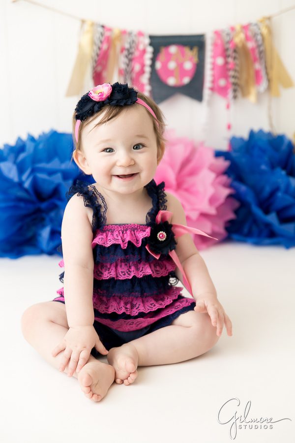 one year old baby girl's ruffle dress portrait