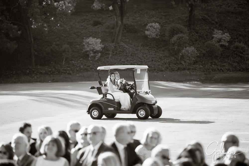 bride rides with her father to the ceremony in a golf cart