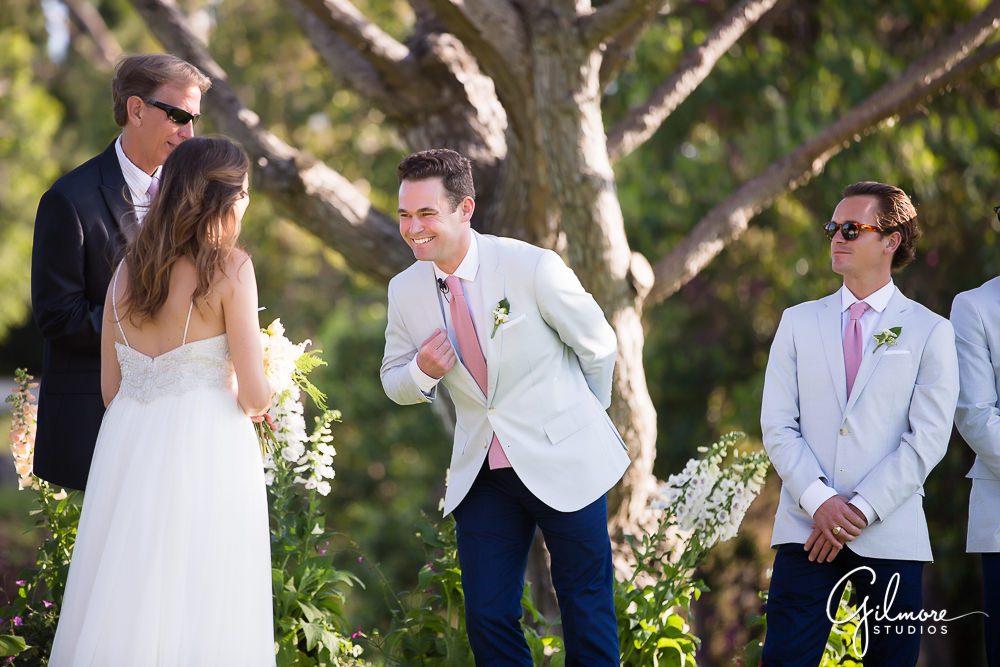 groom makes the bride laugh at the wedding ceremony