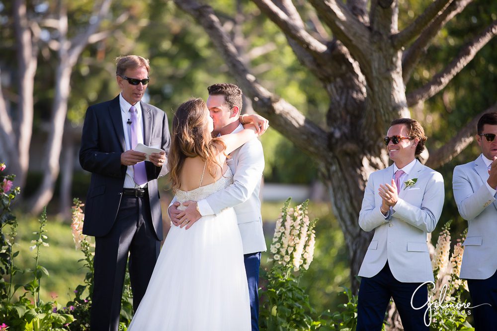 groom kissing the bride during the wedding