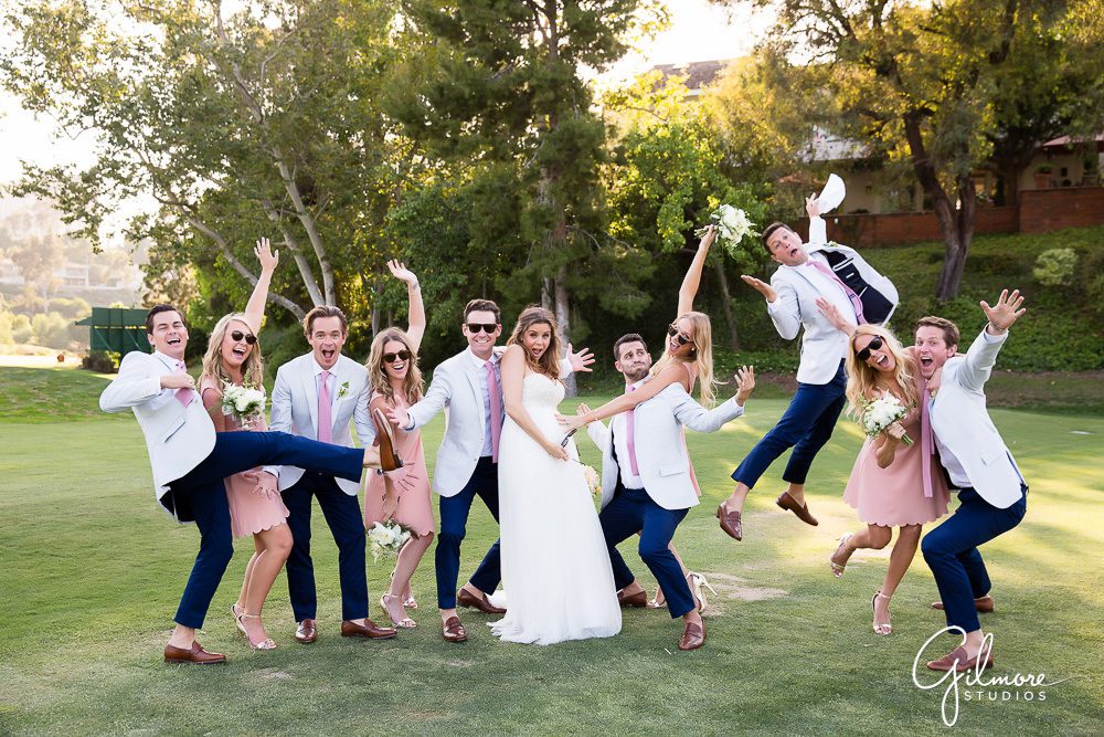 candid wedding party photo on the green at Big Canyon golf course