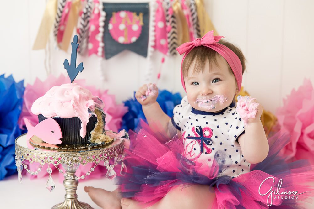 baby girl eating her buttercream frosting birthday cake