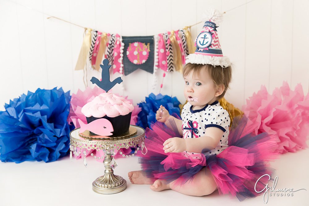 1 year old birthday girl getting ready to eat cake Costa Mesa cake smash photographer