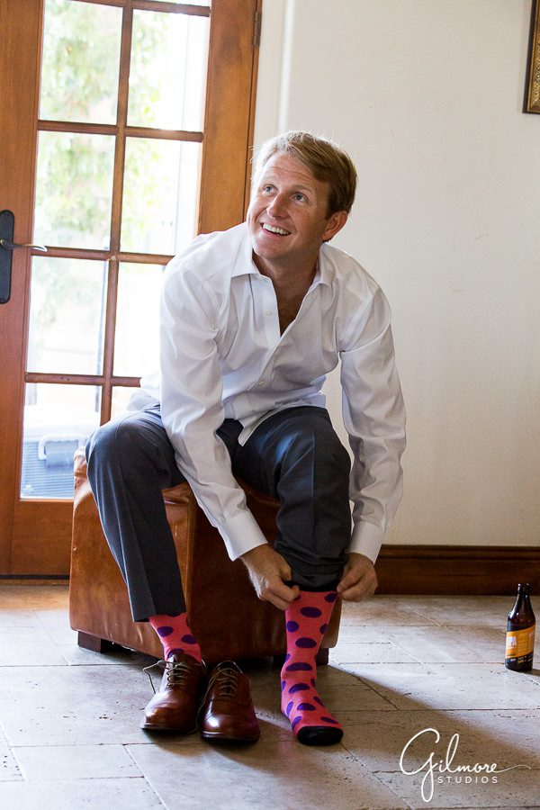 Groom getting ready for the wedding with colorful socks