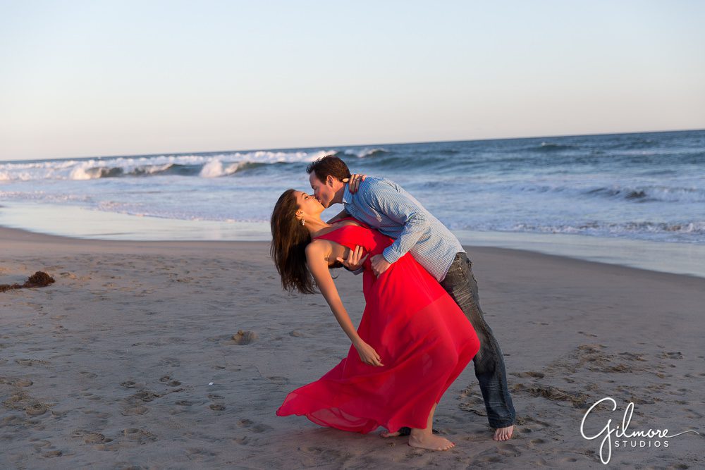 a dip and a kiss engagement photo