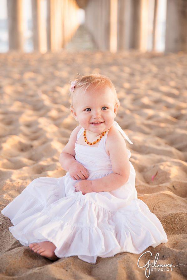 baby girl plays in the sand on the beach