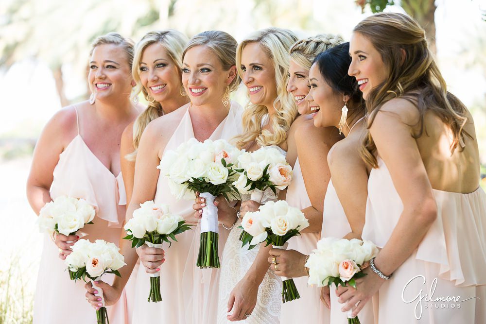 bridesmaids wearing pink dresses and holding bouquets at the Bougainvillea Estate