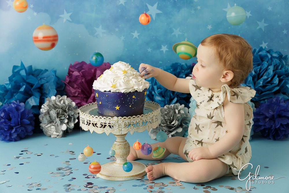 outer space cake theme with planets and stars