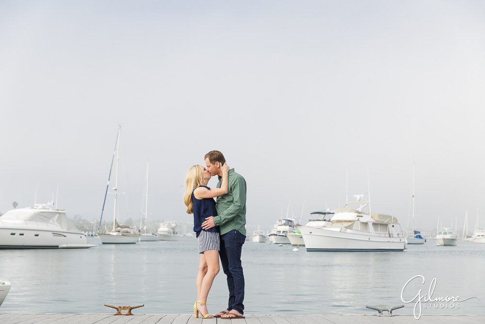 Couple kisses on the docks - Newport Harbor engagement session