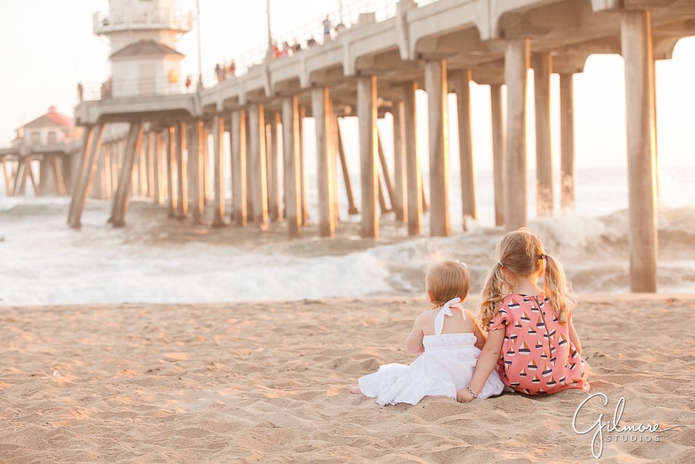 little kids watching the surf in Huntington Beach, CA