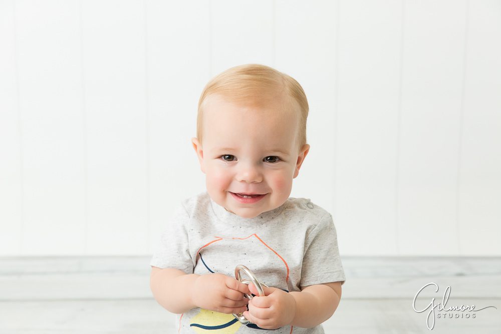 Little boy gets ready for his first birthday cake smash session