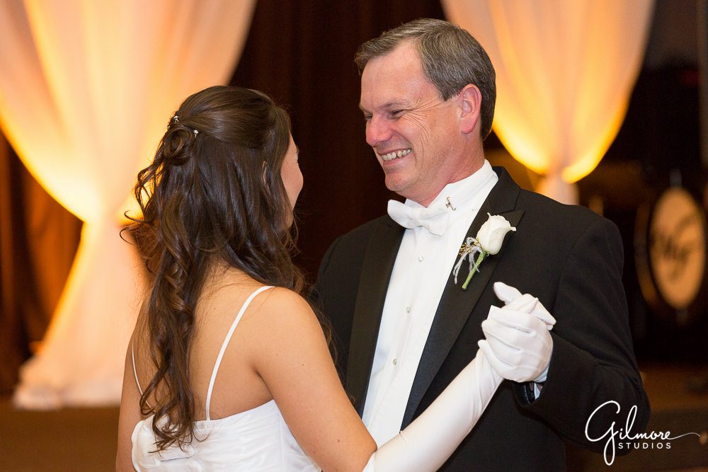 Father smiles at his debutante daughter at the waltz dance