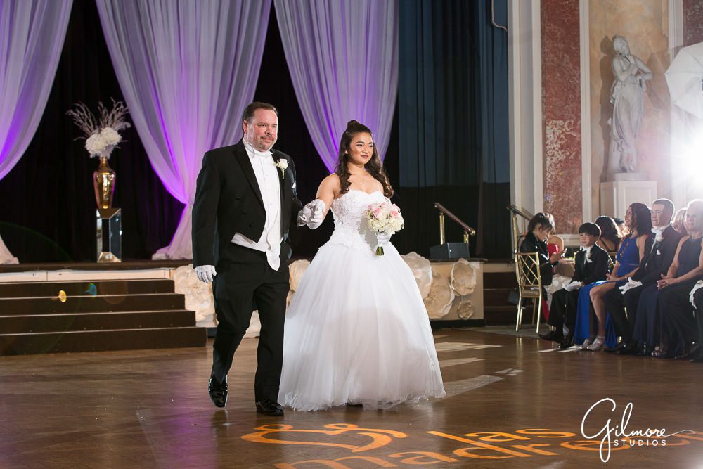 Debutante and father walking at the Evergreen Ball.