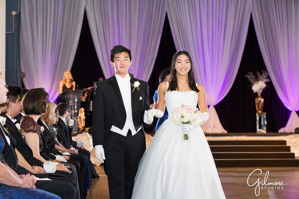 Escort walks with the debutante at the Evergreen Ball.