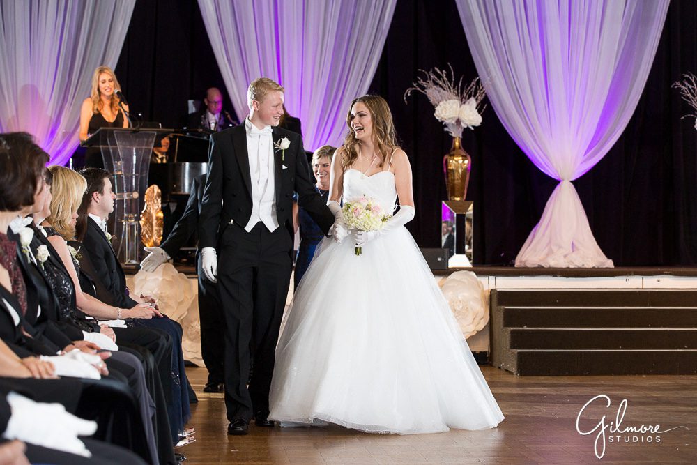 Father walks with daughter at the debutante ball.