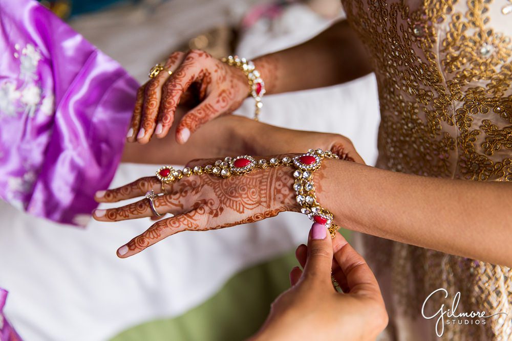Mehndi indian wedding henna tattoo, bride's hands and jewelry