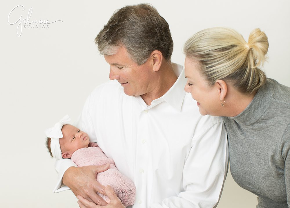 Grandparents holding their brand new grand daughter