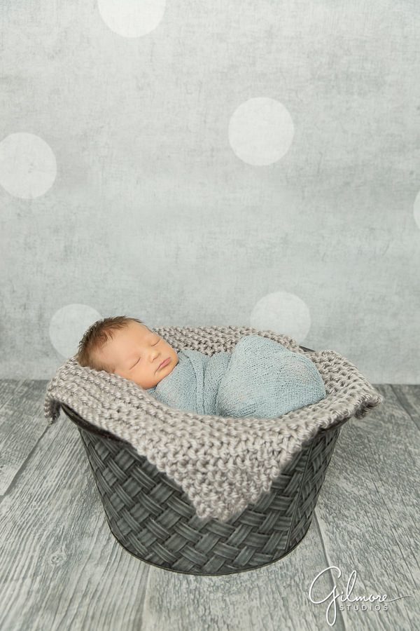 grey dot background, basket, and knitted blanket
