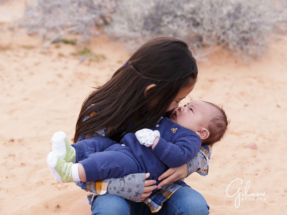 big sister holding baby brother at the Valley of fire family portrait