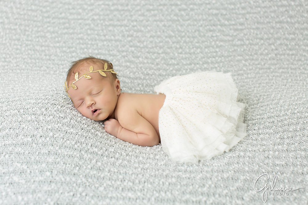 newborn baby girl wearing a white tutu