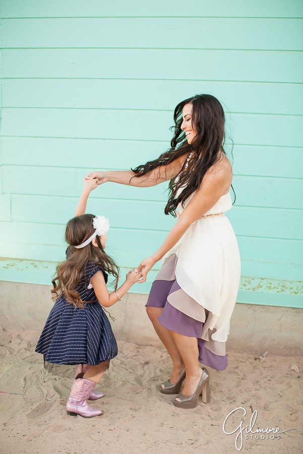 Crystal Cove family photographer, mother dancing with her little girl by the beach