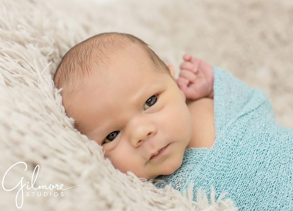 cute baby boy wrapped in teal, Newport Beach lifestyle photography