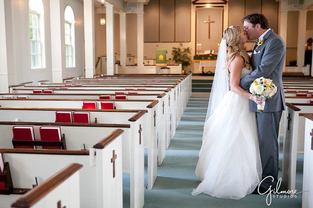 couple kissing in the aisle at the CDM community church Newport Beach