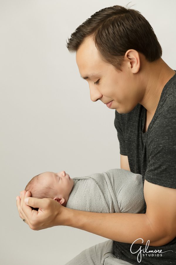 new dad holding his baby boy, OC newborn photographer