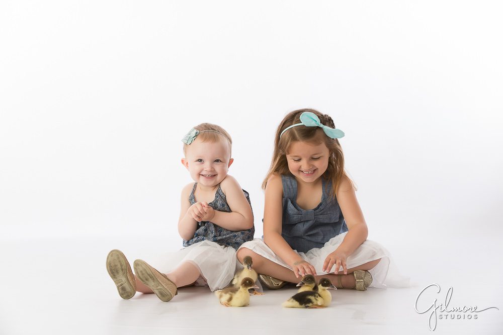 sisters playing with baby ducklings at Gilmore Studios