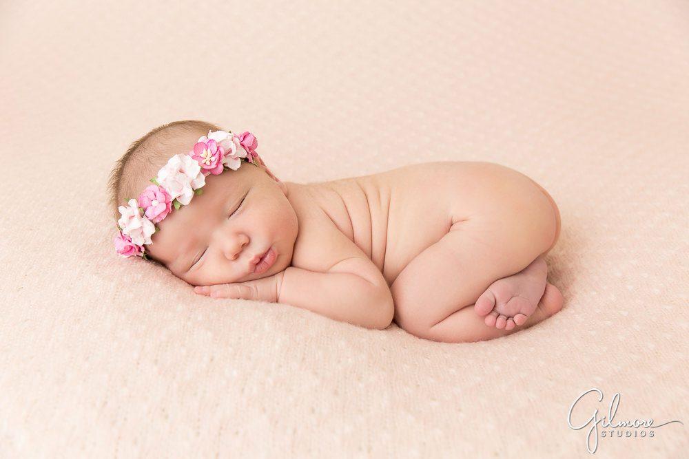 newborn baby girl wearing floral headband