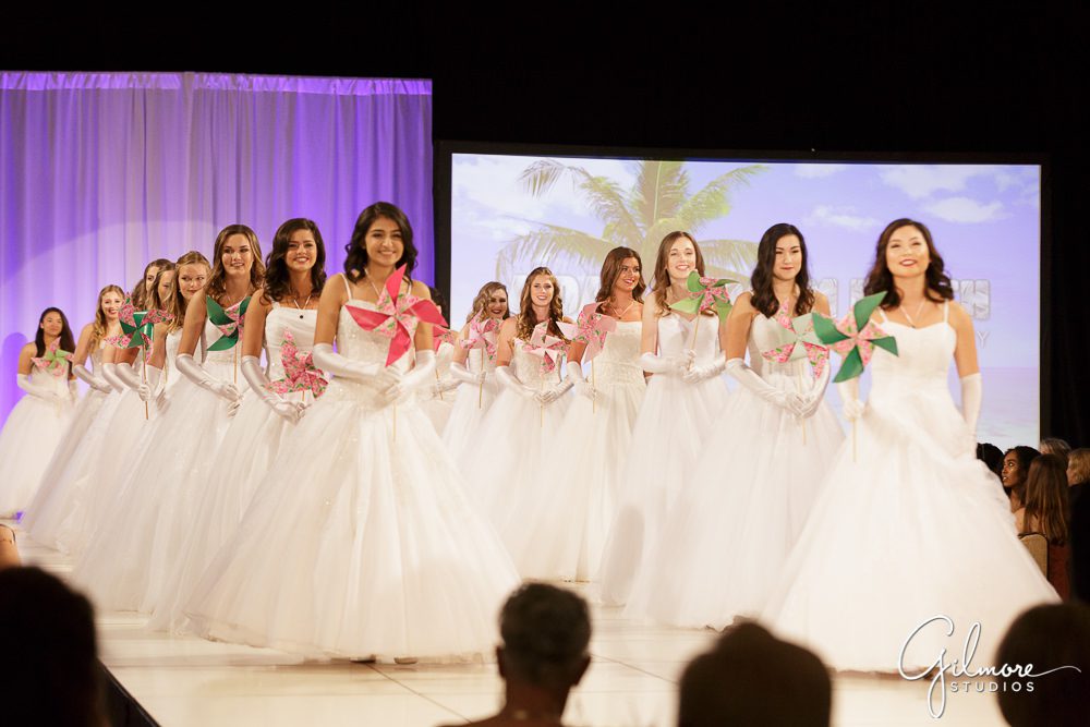 All debutantes walk out on the stage for a bow