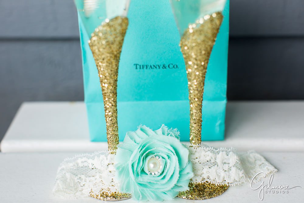 Tiffany & Co. teal bag, wedding rings, toasting glasses, and garter