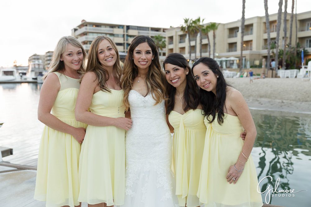 bridesmaids get together for a photo outside of the Balboa Bay Resort wedding