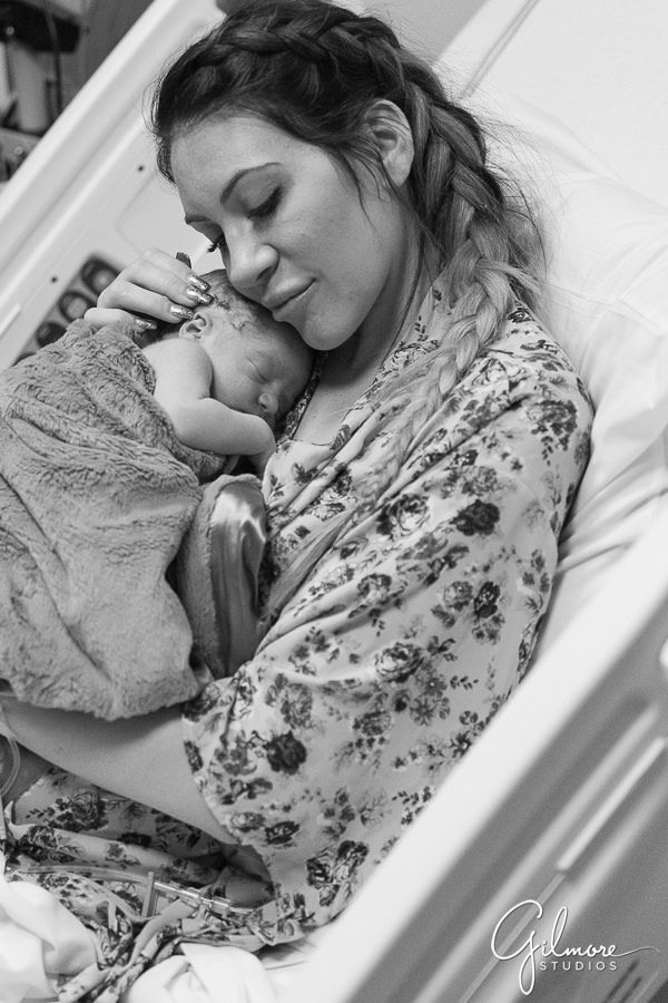 mother holds her brand new baby boy, Hoag Hospital Newborn Photographer