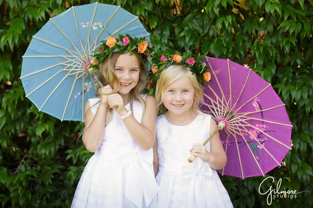 Flower girls holding their parasols before the wedding