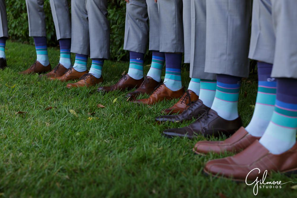 groomsmen showing off their colorful socks