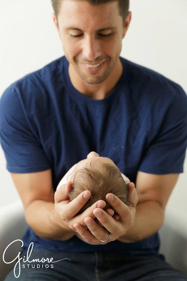 father holding his newborn baby girl, posing, portrait session