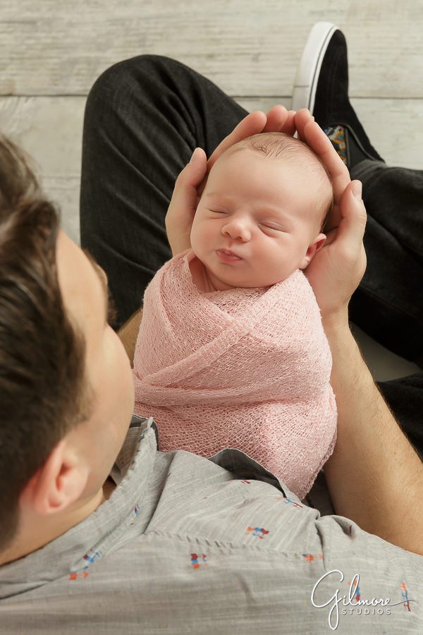 daddy holds his brand new baby girl, newborn photo