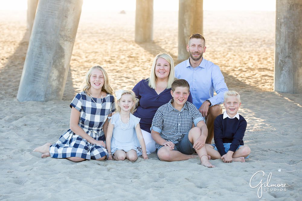 Huntington Beach Family Photographer, sitting in the sand under the HB pier