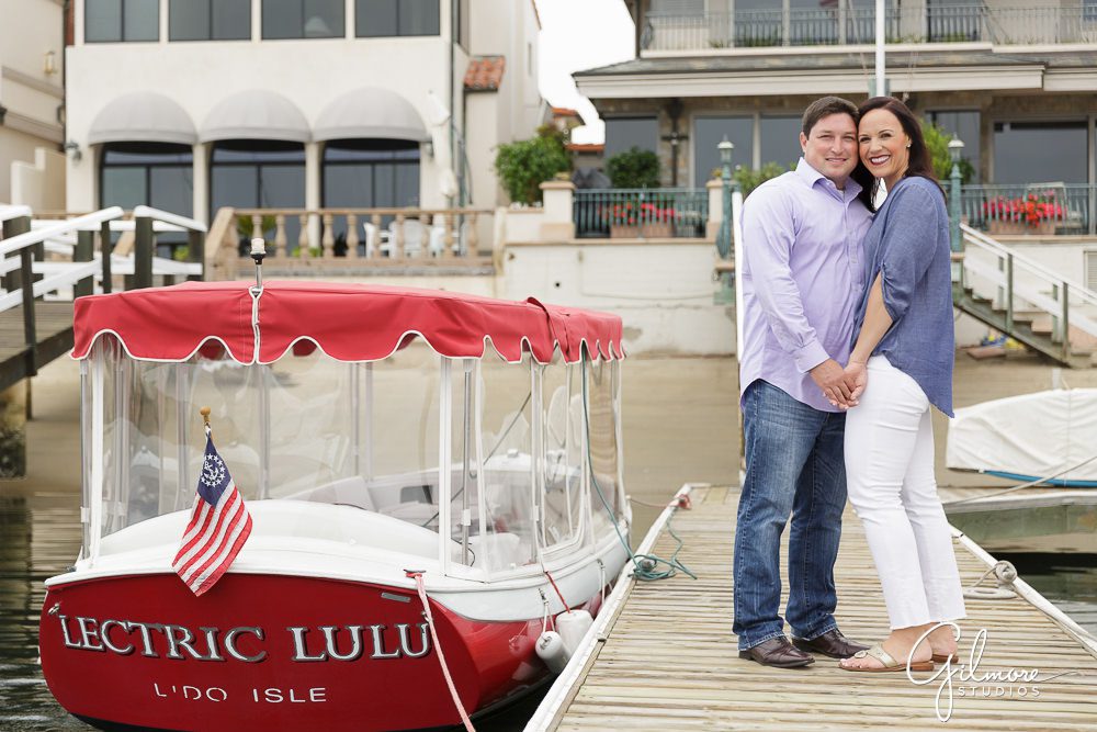 Lido Isle Engagement Photography, red and white Duffy boat