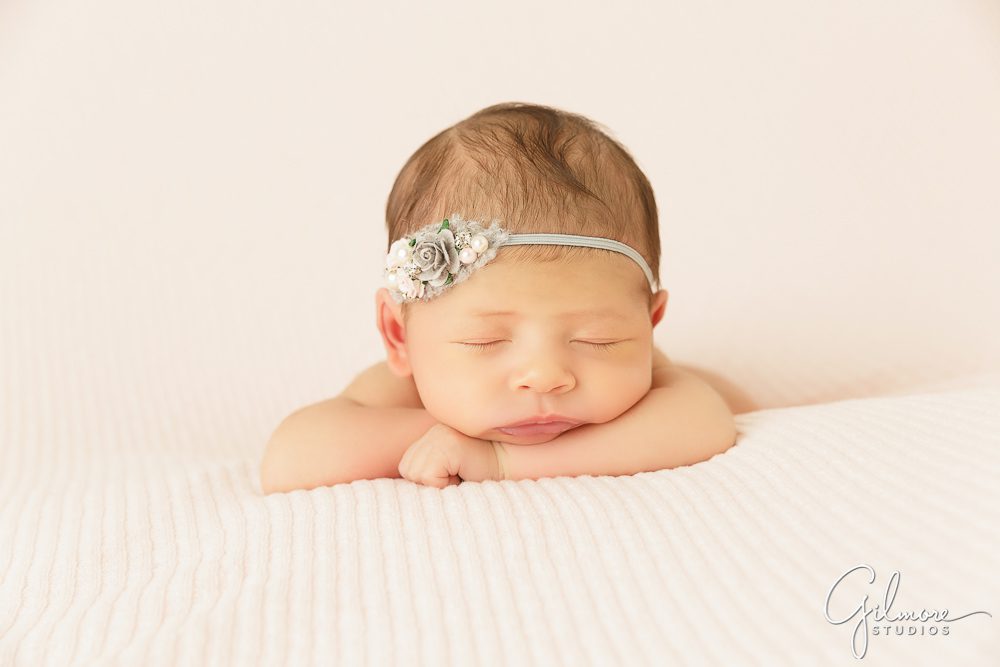 Irvine newborn baby photographer, girl posing, pink and grey, headband, natural colors