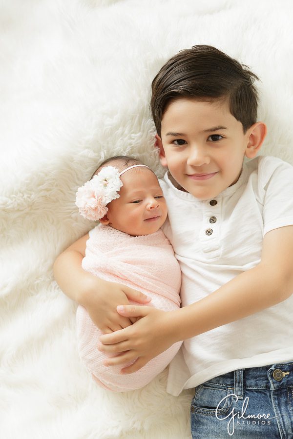 little boy holds his new baby sister, No. 2 willow lane headband
