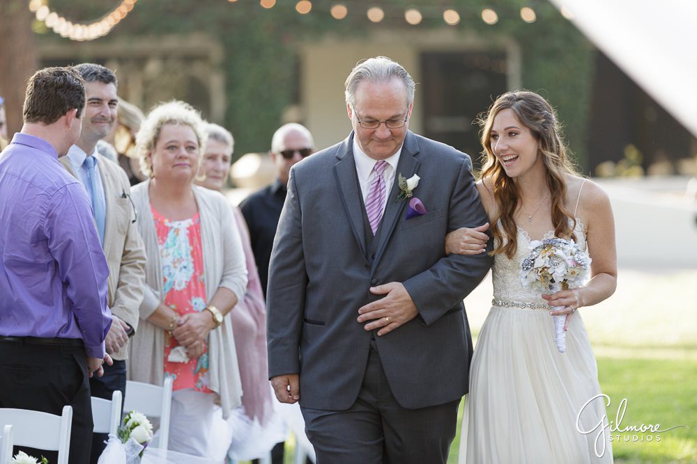 dad walks with the bride down the aisle