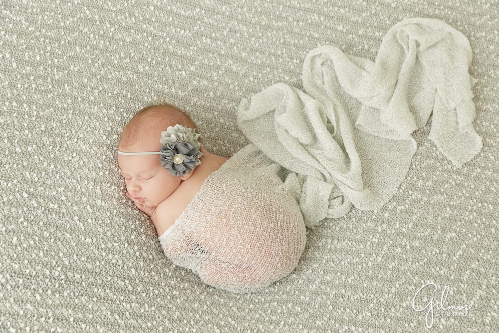 Orange County newborn photography, grey tones, wrap, see through knit, floral headband