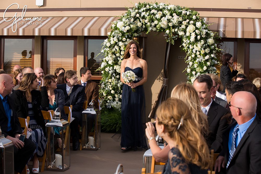 bridesmaid, navy blue dress, Surf and Sand wedding, ceremony, floral arch, florist, flowers, decor