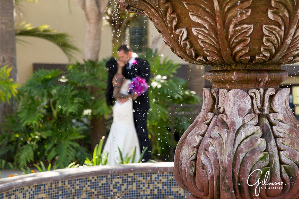 Hyatt Regency Newport Beach, bride, groom, photographer, kiss, wedding, dress, fountain, portrait, flowers, purple, bouquet, bridal