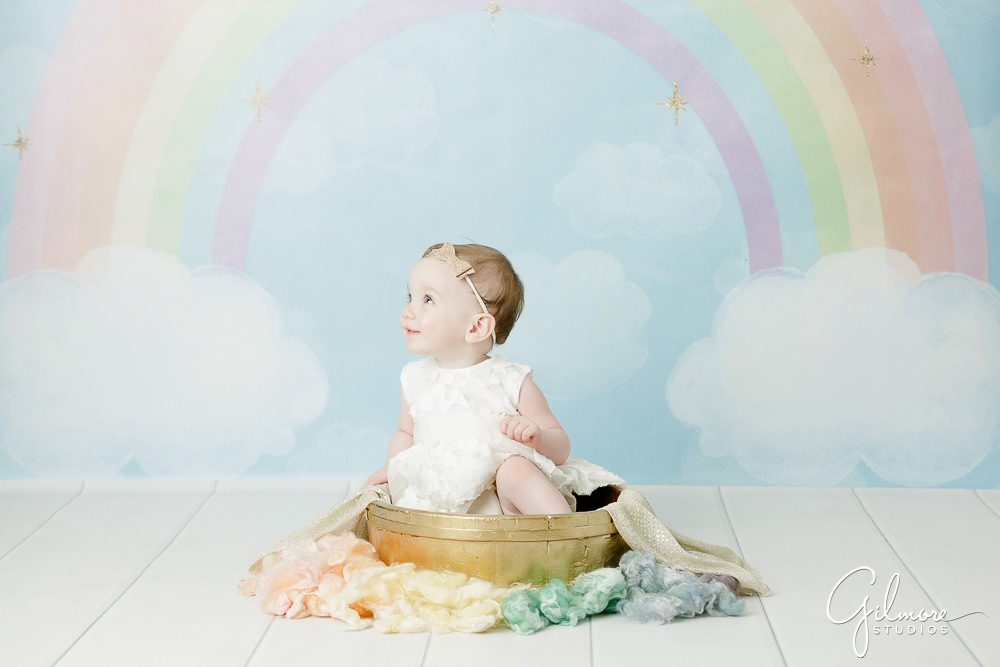Unicorn Theme Cake Smash, rainbow backdrop, blue sky background, photo shoot, portrait studio, props, outfits