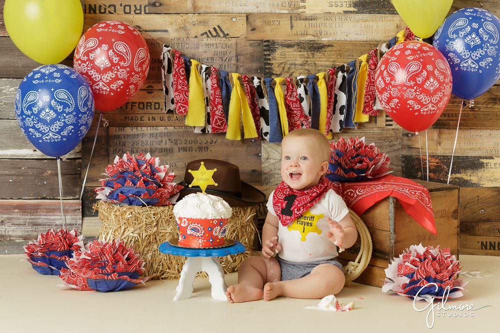 Cowboy Cake Smash, theme portrait session, hat, bandanna, baby, first birthday, pom poms, streamers, props